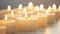 Multiple lit tea candles, creating a warm, soft glow on a gentle background