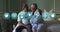 Multiple medical icons against african american senior couple laughing while sitting on bed