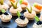 Multiple mini puff pastry tartlets with savory filling.