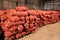 Multiple onion harvest in red sacs in the warehouse