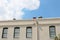 Multiple paned windows along the top of a commercial office building