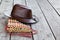 Multiple pipes pan flute and leather cowboy brown hat lying on square-edged flooring, copy space