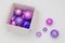 Multiple purple Christmas balls, shiny ornaments in box, 3d rendering. concept for happy new year and christmas