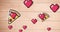 Multiple red heart floating and pizza slice icons spinning against wooden background