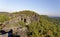 Multiple rock formations surrounded by dense growth of greenery