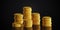 Multiple stacks of gold money coins on dark black background, wealth, savings or finance concept