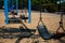 Multiple Swings hang still without children to play on them at a local park