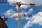 Multiple tall construction cranes against blue sky..