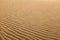 Multiple undulated waves patterns on textured sand dune..