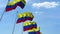 Multiple waving flags of Colombia against the blue sky. 3D rendering