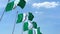 Multiple waving flags of Nigeria against the blue sky. 3D rendering