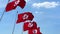 Multiple waving flags of Tunisia against the blue sky. 3D rendering