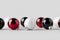 Multiple white, red and black glossy Christmas balls mockup on a seamless grey background