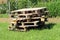 Multiple wooden pallets left on small pile in backyard for later use