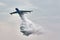 Multipurpose amphibian aircraft Beriev Be-200ES drops water. The aircraft demonstrates fire fighting over the Black Sea water