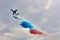 Multipurpose amphibian aircraft Beriev Be-200ES drops water in the colors of the Russian tricolor flag.