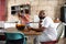 Multiracial african american family in home kitchen with father using technology