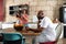 Multiracial african american family in home kitchen with father using technology