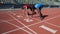 Multiracial athletes in starting position, ready to run after command, marathon