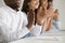 Multiracial business audience people applauding sitting at conference table, closeup