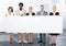 Multiracial businesspeople holding placard