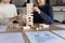 Multiracial businesswomen play build wood block stacking game at workplace