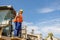 Multiracial construction worker using heavy machinery in plant