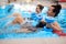 Multiracial couple attending water aerobics class in a swimming pool