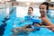 Multiracial couple attending water aerobics class in a swimming pool