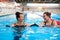 Multiracial couple attending water aerobics class in a swimming pool