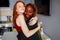 Multiracial couple girlfriends in love embracing in room