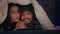 Multiracial couple Hispanic woman Indian man Arabian boyfriend girlfriend happy family under blanket cover watching