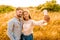 Multiracial couple in love having fun with smartphone taking selfie in nature. Hispanic girl photography herself with boyfriend at