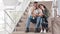 Multiracial couple multiethnic newlyweds afro American man and Hispanic woman sitting in airport terminal with tickets