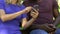 Multiracial couple sitting on bench and booking tickets to their vacation trip