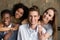 Multiracial couples hugging smiling to camera, posing for pictur