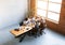 Multiracial Coworkers Holding Hands Sitting At One Table In Office