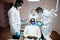 Multiracial dentist doctors team. African american man patient at UV protective glasses. His teeth treated with the help of a