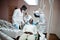 Multiracial dentist doctors team. African american man patient at UV protective glasses. His teeth treated with the help of a