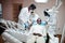 Multiracial dentist doctors team. African american man patient at UV protective glasses. His teeth treated with the help of a