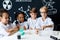 Multiracial diverse kids with test tubes studying chemistry at school laboratory