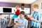 Multiracial elementary schoolboys using smart phone in classroom during school breaktime