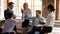 Multiracial employees giving high five during group briefing in office