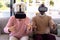 Multiracial excited senior friends enjoying virtual reality simulators on sofa in retirement home