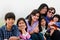 Multiracial family of seven sitting on beach