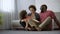 Multiracial family sitting together and laughing, spending nice time together