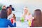 Multiracial female friends enjoying meal in restaurant