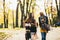 Multiracial female friends walking in teh autumn park