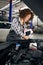 Multiracial female repairman pours glass washer into the tank