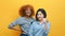 Multiracial friendship or lesbian relationship concept. African american and asian women with thumbs up isolated on